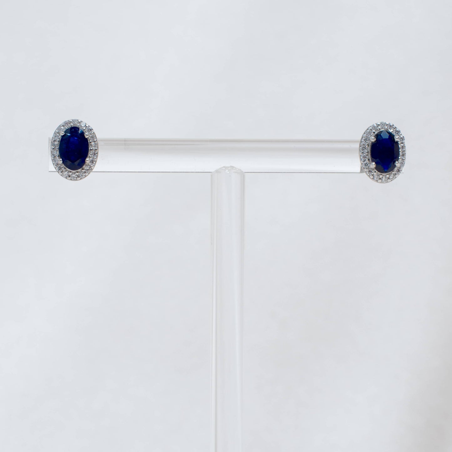 Pair of earrings with blue gemstones on a white background