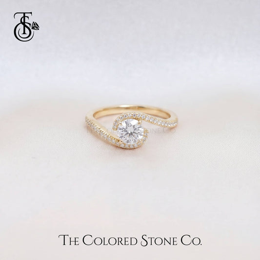 Gold Engagement ring with a diamond on a light background, featuring 'The Colored Stone Co.' logo.