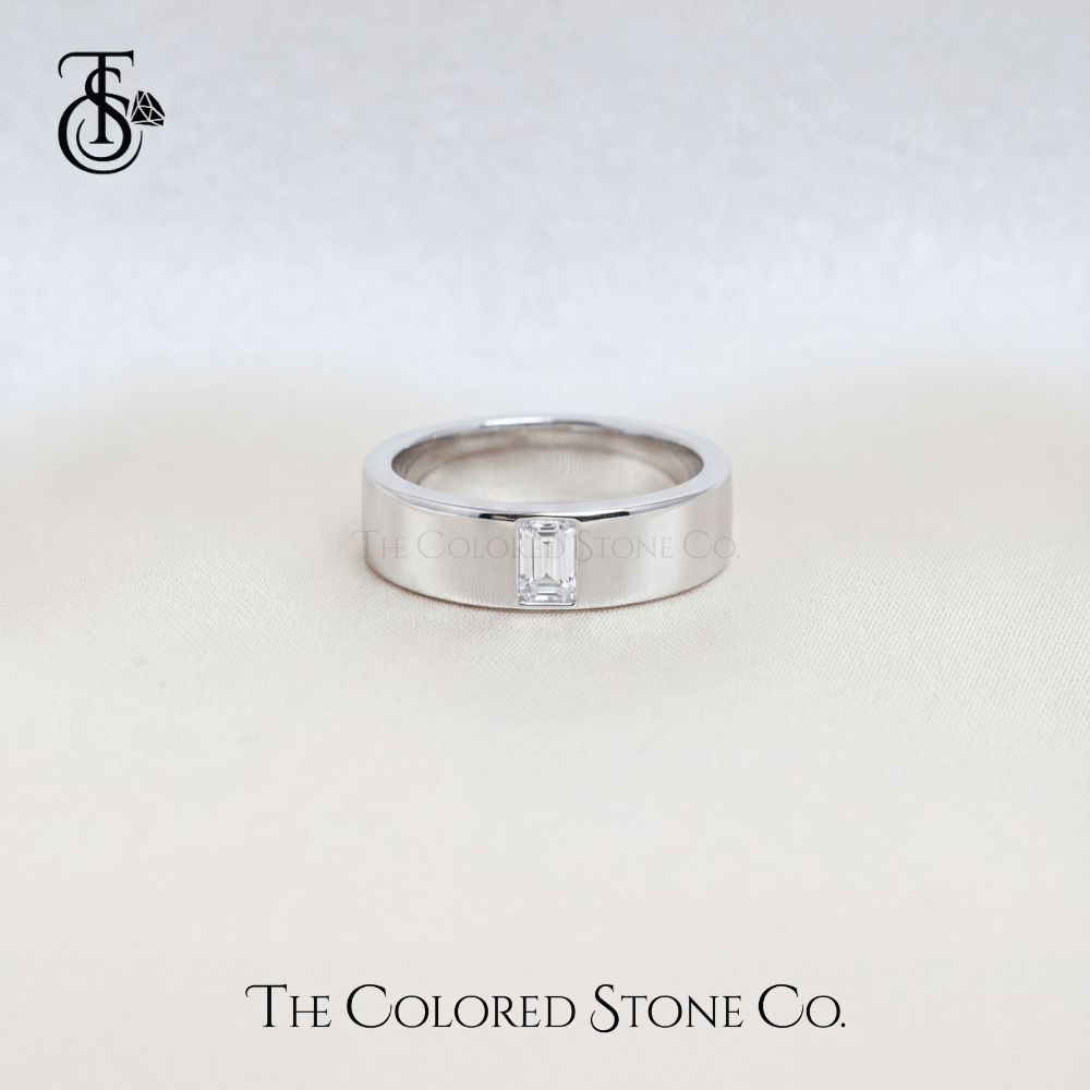 Silver men's wedding ring with a diamond on a light gray background, featuring 'The Colored Stone Co.' branding.
