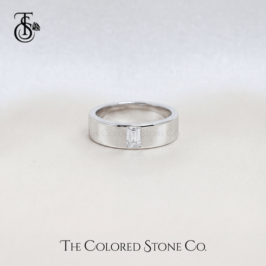 Silver men's wedding ring with a diamond on a light gray background, featuring 'The Colored Stone Co.' branding.