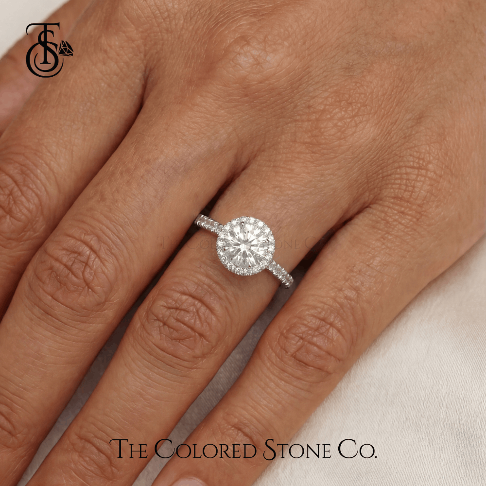 white gold Diamond engagement ring on a hand with 'The Colored Stone Co.' branding.