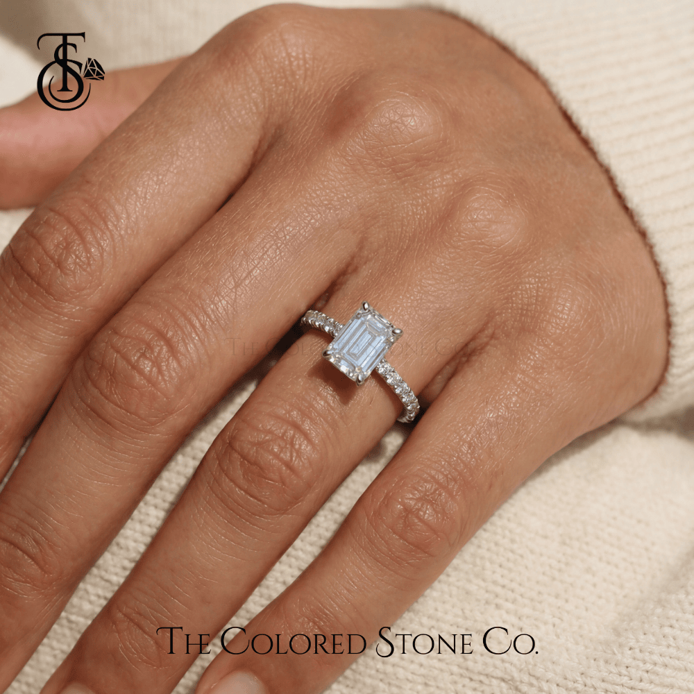 white gold Diamond engagement ring on a hand with 'The Colored Stone Co.' branding.