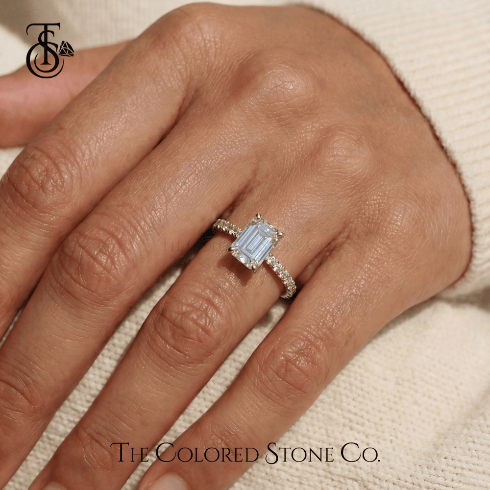 Yellow gold Diamond engagement ring on a hand with 'The Colored Stone Co.' branding.