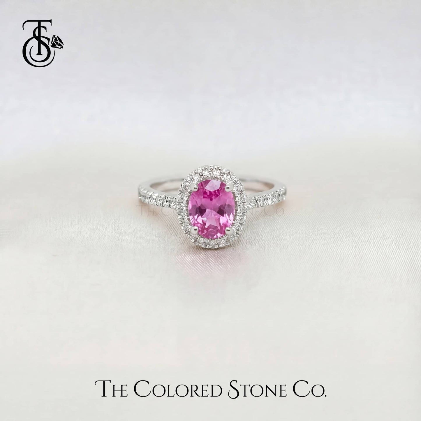 white gold engagement Ring with a pink sapphire gemstone on a white background, featuring 'The Colored Stone Co.' branding.