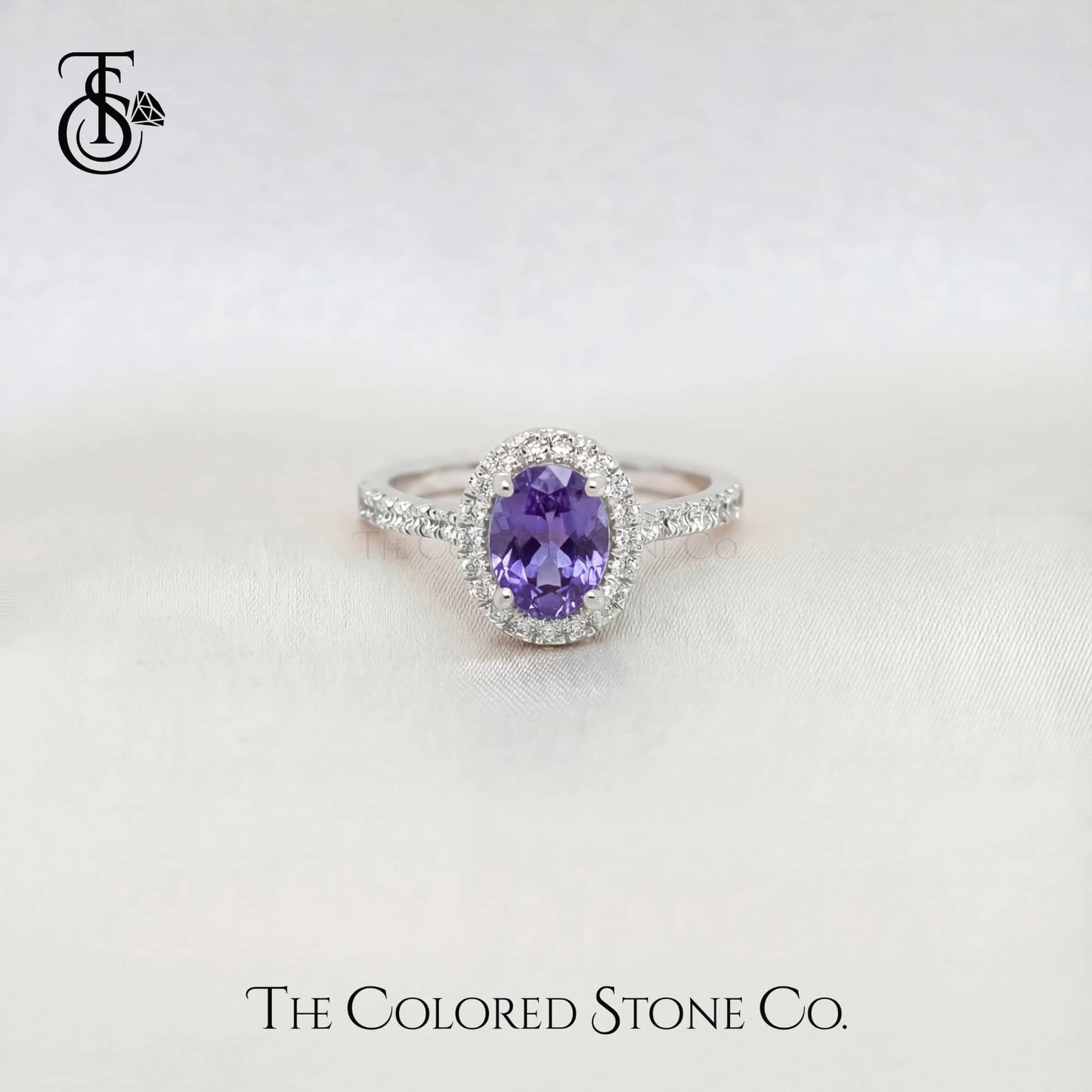 White gold sapphire Ring with a purple sapphire gemstone on a white background, branded 'The Colored Stone Co'.