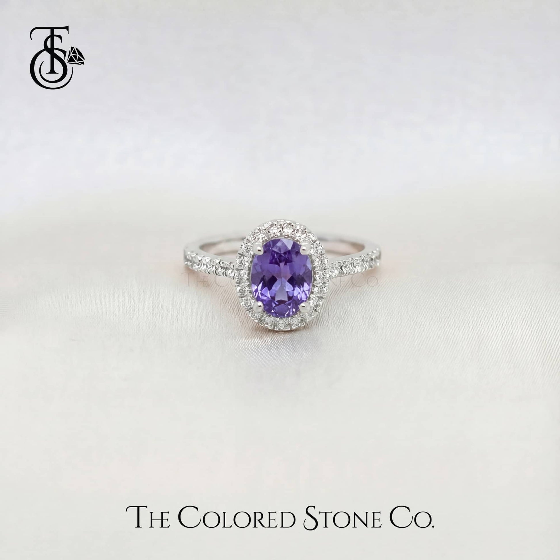 White gold sapphire Ring with a purple sapphire gemstone on a white background, branded 'The Colored Stone Co'.