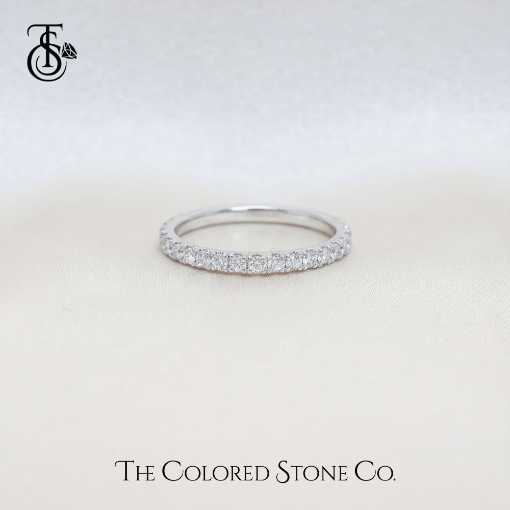 white gold Diamond wedding ring with small stones on a light gray background, featuring 'The Colored Stone Co.' branding.