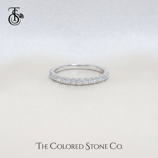white gold Diamond wedding ring with small stones on a light gray background, featuring 'The Colored Stone Co.' branding.