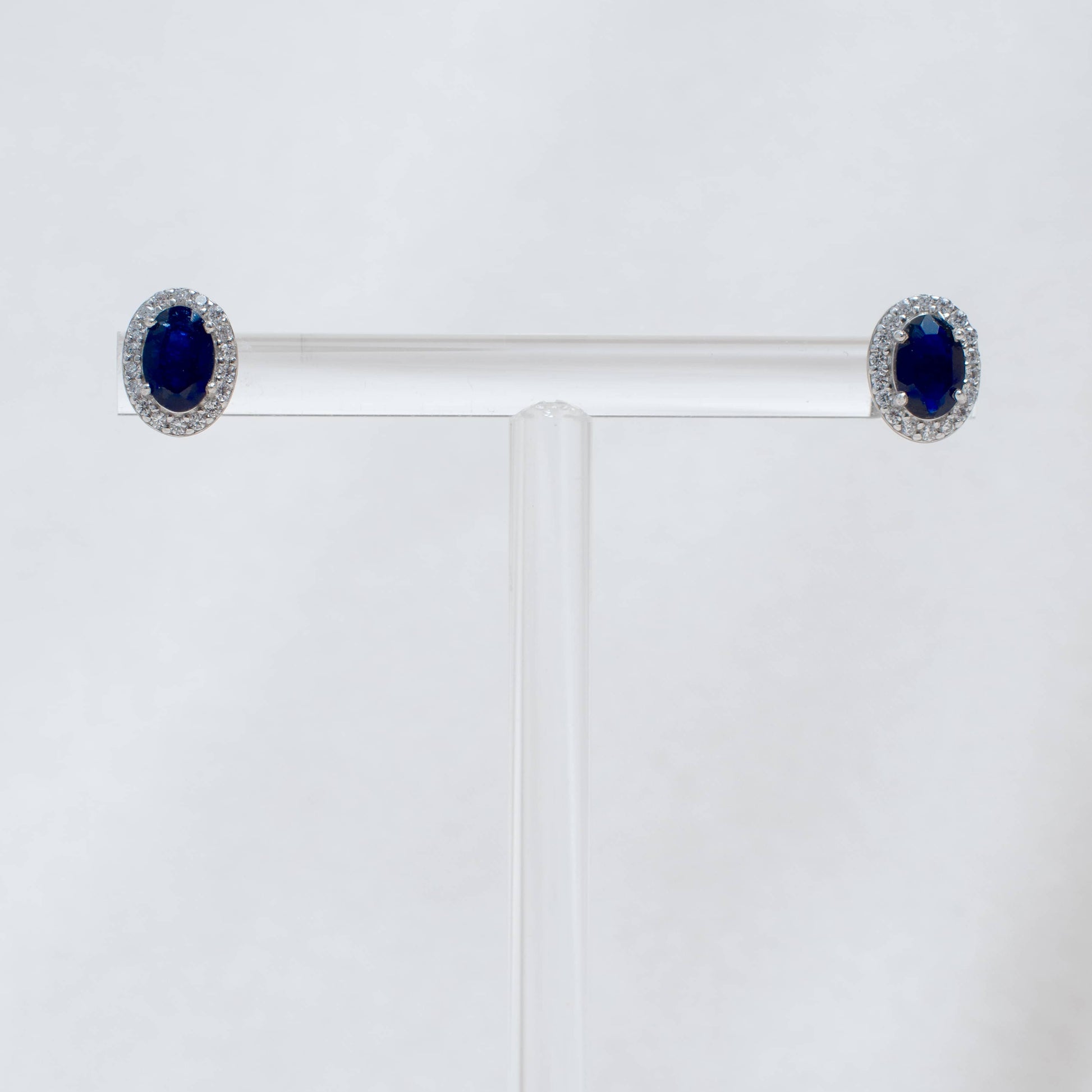 Pair of earrings with blue gemstones on a white background
